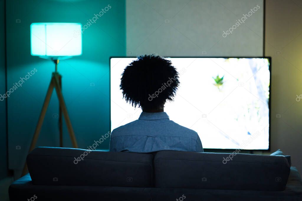 African American Streaming And Watching Movie On TV Screen