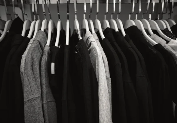 Dark Male Clothes on Hangers