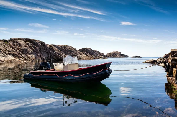 Landscape with boat near Lindesnes, Norway. The coast of southern Norway with an ocean view, rocky sea coast, South Norway, Lindesnes Fyr beacon.