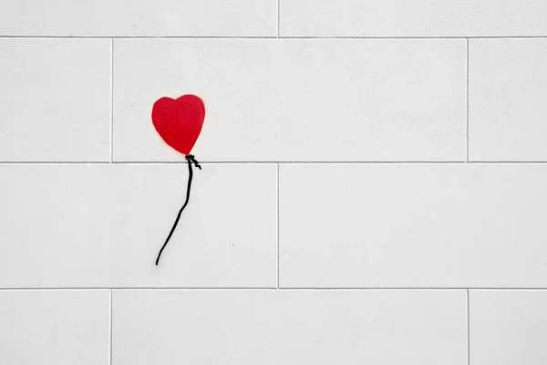 Heart shape balloon painting on the wall tiles.