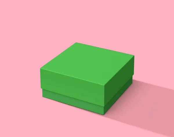 Boîte carrée verte sur fond rose — Photo