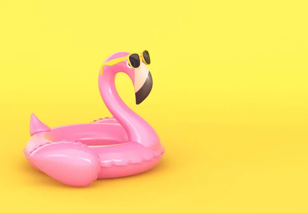 Flamingo inflável em óculos de sol no fundo amarelo — Fotografia de Stock
