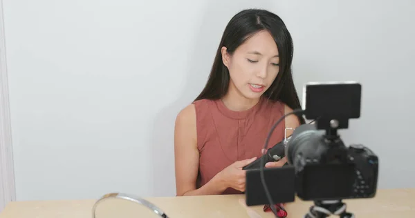 Woman taking video of making hair for posting online