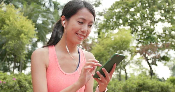 Sport woman listen to music on cellphone at outdoor