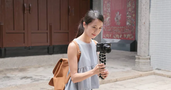 Woman holding camera and visit traditional chinese architecture building and looking around