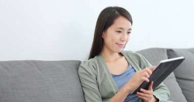 evde tablet bilgisayar kullanan kadın