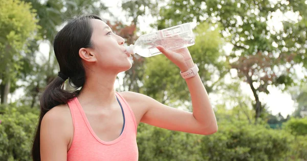 Sport woman drink of water after jogging at outdoor