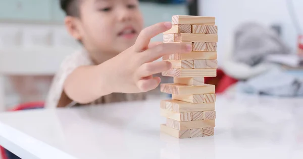 Asian boy play wooden blocks
