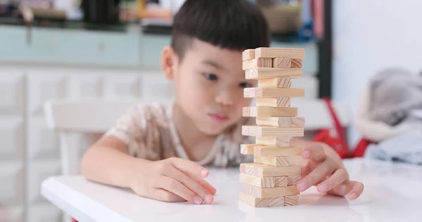 Kids play with wooden blocks at home