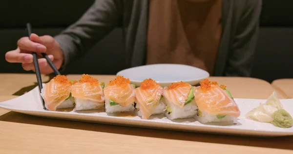 Woman enjoy the Japanese sushi in restaurant