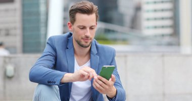 Şehirde Smartphone kullanarak iş adamı