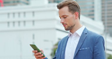 Cep telefonunuzun ve Hong Kong şehrinde beyaz iş adamı