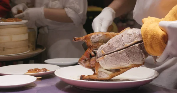 Chef preparing Peking duck in restaurant