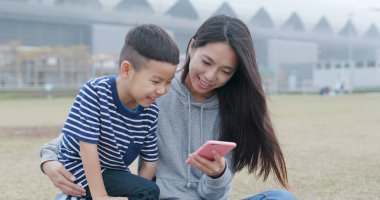 Anne oğlu ve birlikte smartphone kullanarak konuşun 