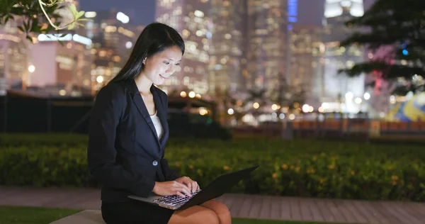 Businesswoman working on laptop computer at night