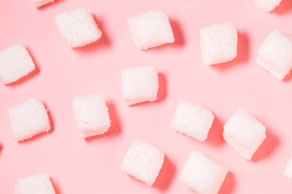 White marshmallows on pink background