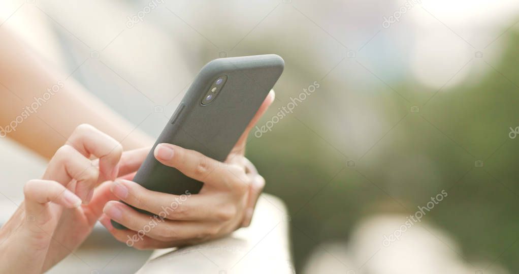 Close up of woman using mobile phone in the evening 