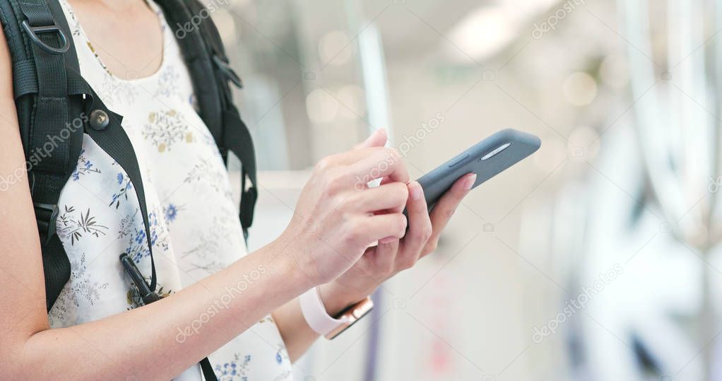 Close up of woman using cellphone on train