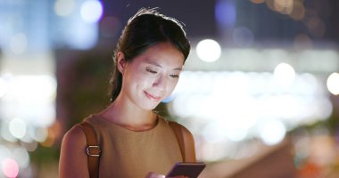 Kentin açık, cep telefonu kullanan kadın