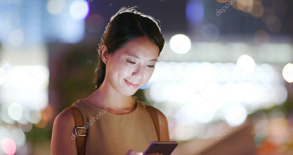 Woman using mobile phone in the city at outdoor