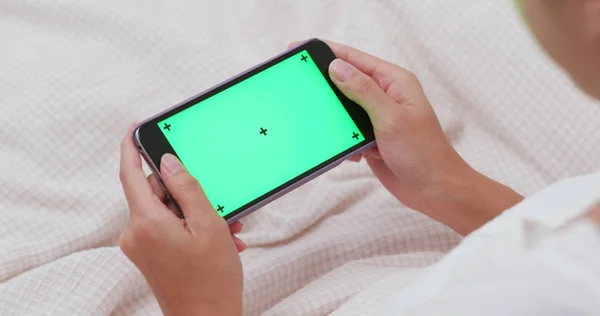 Woman using smartphone with chroma key