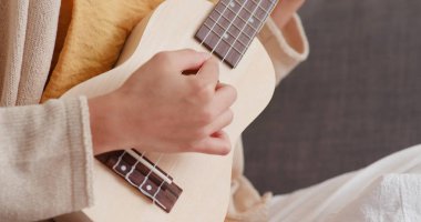 Kadın ukulele ile bir şarkı çal
