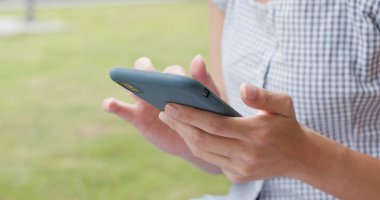 Park adlı cep telefonu kullanan kadın