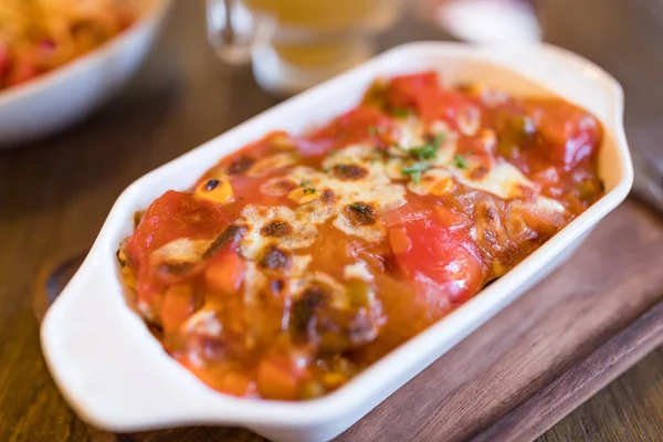 Baked tomato sauce riced with cheese inside restaurant