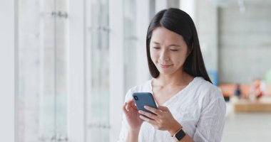 Alışveriş Merkezi içinde cep telefonu app için arayan kadın