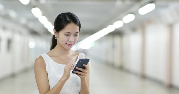 Woman look at smartphone in the evening