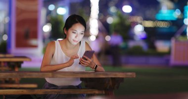 Cep telefonuyla kahve dükkanında geceleri kadın