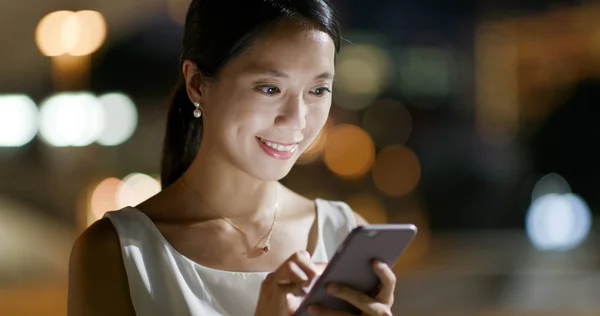 Woman look at cellphone in the evening