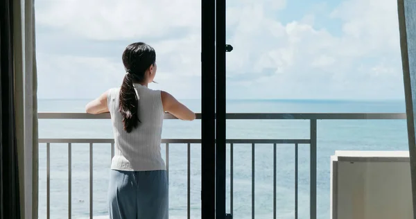 Woman looking  at the sea in balcony