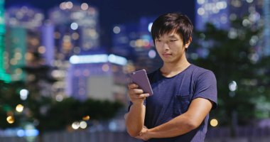 Adam cep telefonuyla şehirde geceleri