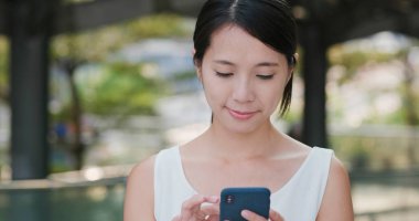 Ofis Kulesi arka plan ile cep telefonu kullanan kadın