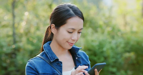 Woman read on mobile phone in city