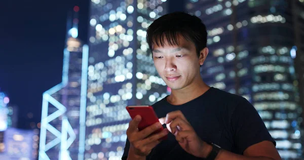 Man look at smart phone at night