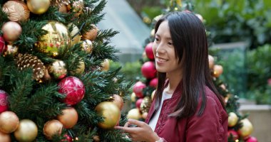 Woman look at the Christmas tree 