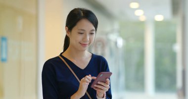 Alışveriş Merkezi içinde cep telefonu kullanan kadın