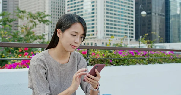 stock image Woman using mobile phone in city