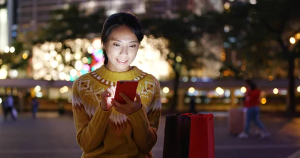 Woman check on mobile phone in city