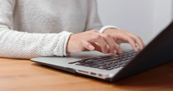 Woman type on computer at home