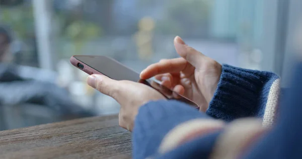 Woman watch on cellphone in coffee shop