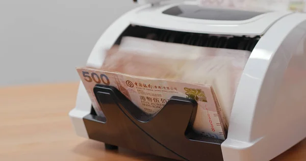 Money counting machine with Hong Kong dollar banknotes
