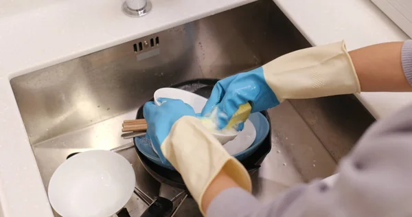 Housewife wash dishes in the kitchen