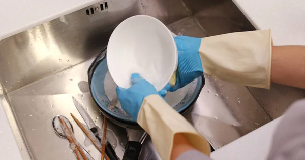 Woman wash dishes at home