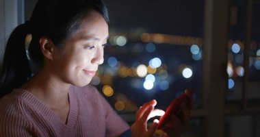 Gece kadın onay üstünde hareket eden telefon