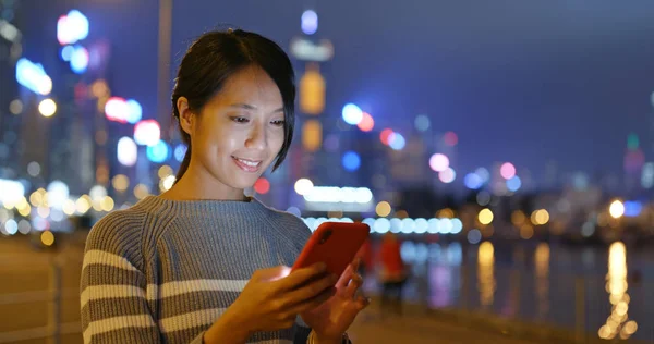 Young woman use of mobile phone at night