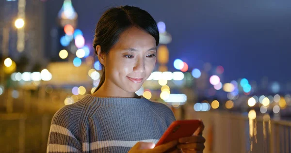 Woman use of mobile phone at night