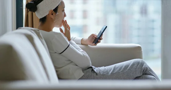 Woman Apply Paper Mask Face Use Mobile Phone Home — Stock Photo, Image